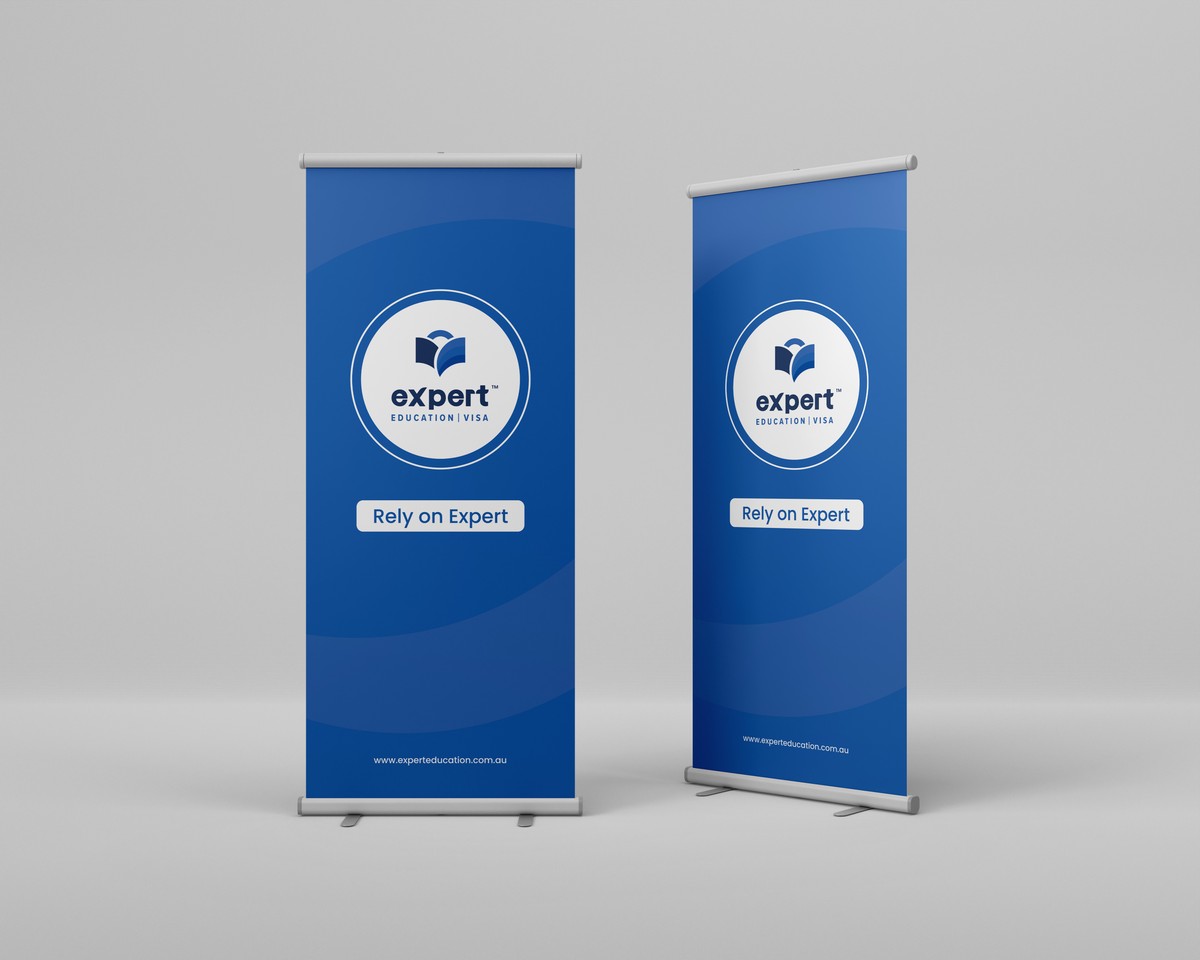 Two blue Expert roll-up banners standing in a grey room