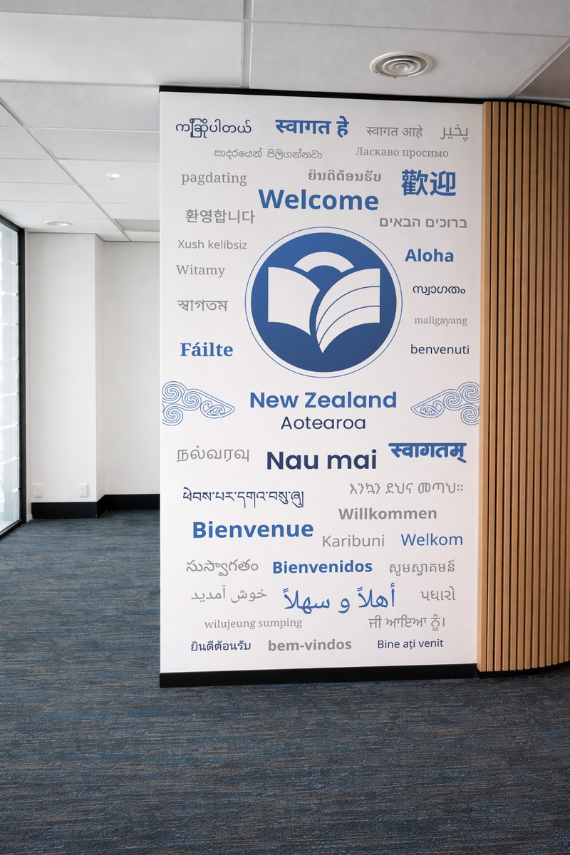 An office wall graphic saying welcome in many languages around the Expert logo