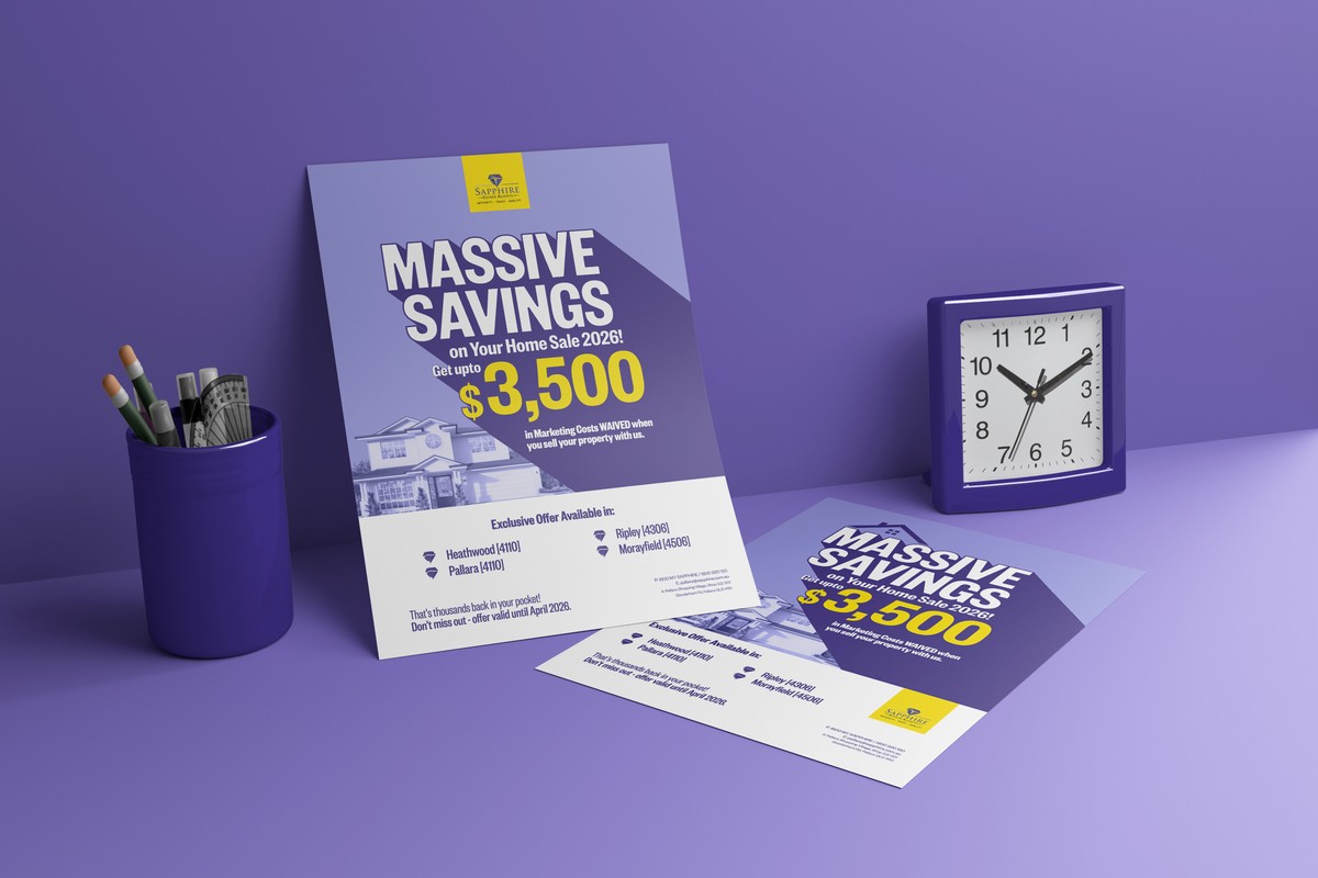 Purple Massive Savings flyers on a desk beside a clock and pen holder
